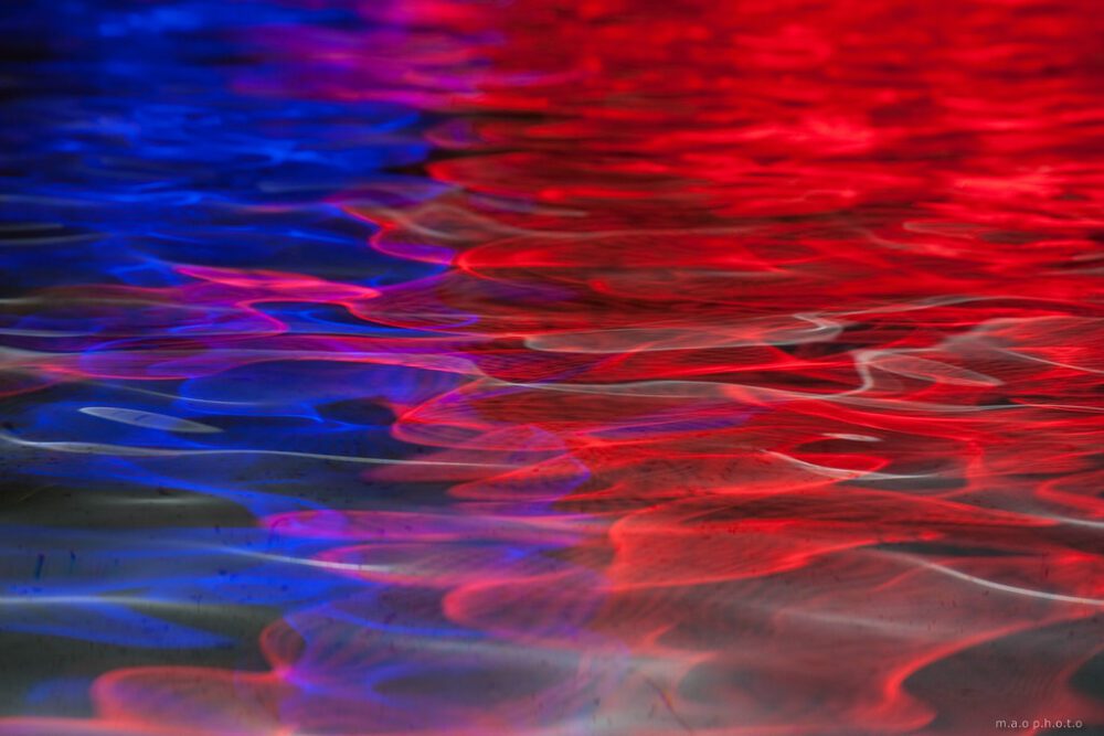 water with red, blue and purple reflection