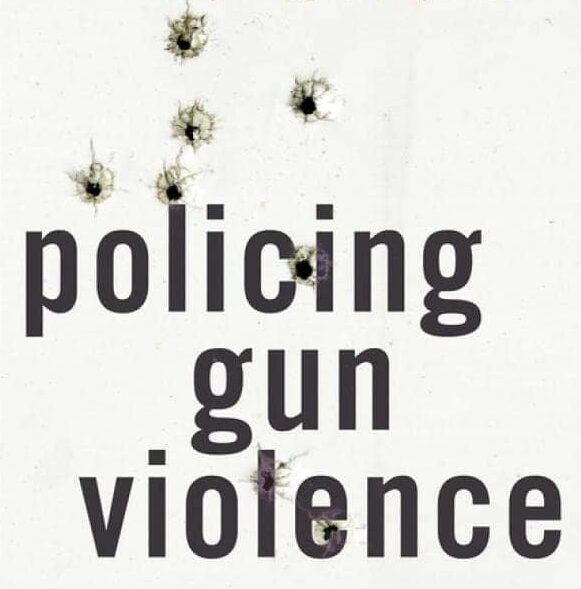 The cover of Phil Cook's book, Policing Gun Violence. It has bullet holes in it.